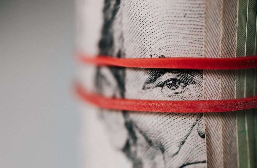 roll of american dollar banknotes tightened with band